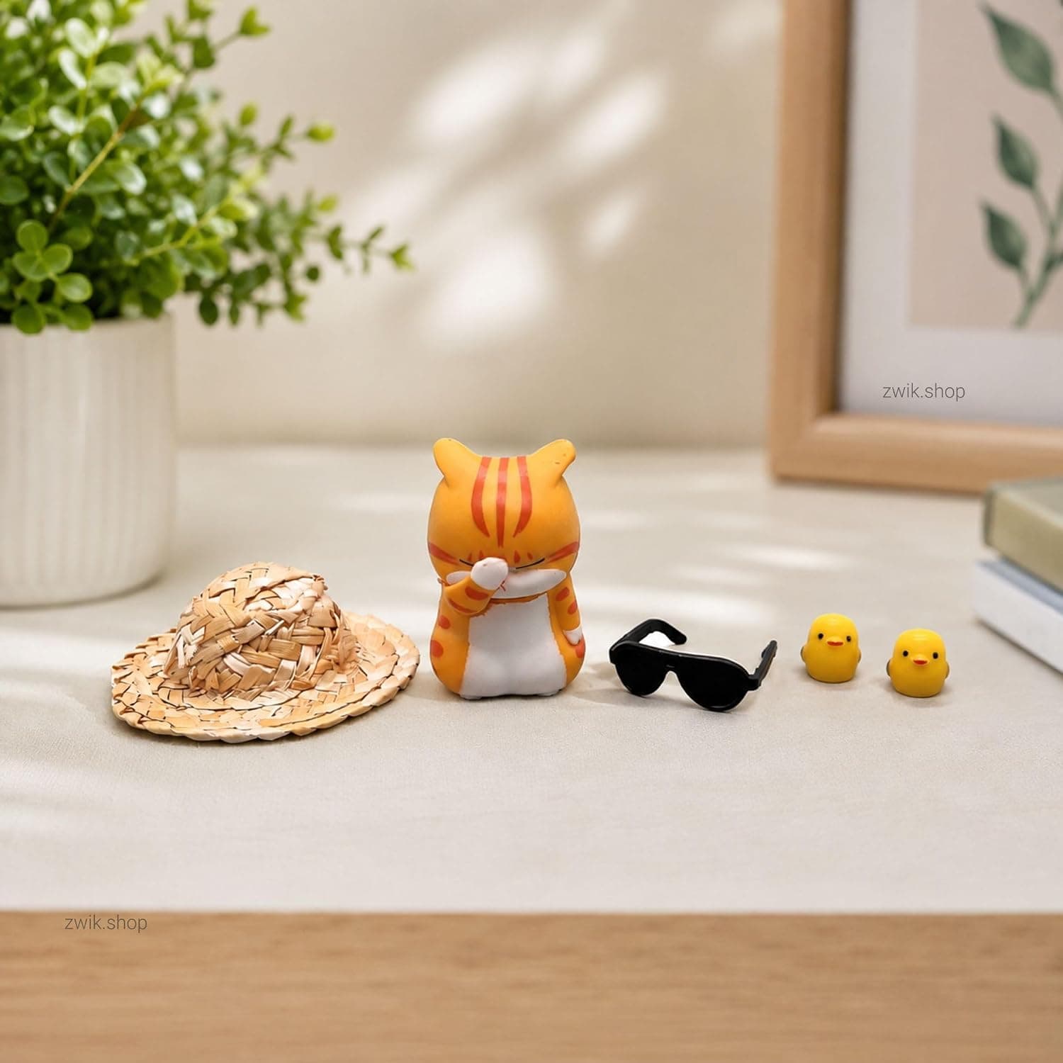 Straw hat cat set laid out on a desk